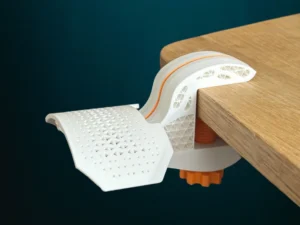 Innovative tape dispenser featuring a unique design, securely clamped to a wooden table, with a patterned tape roll extending for easy access.